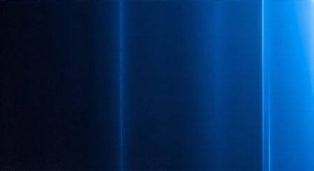 Dark blue gradient background texture with light beamsの素材