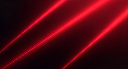Red laser beams shining on a dark background with a white space belowの素材