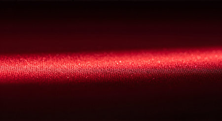 A bright red light beam shining in a dark room or spaceの素材