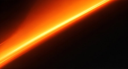 A bright orange streak of light on a dark backgroundの素材