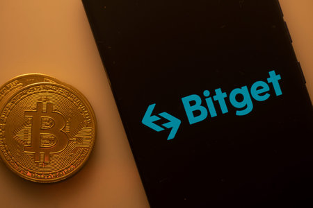 Dhaka, Bangladesh 22 September 2025:Bitcoin coin adjacent to Bitget logo on a black background,...