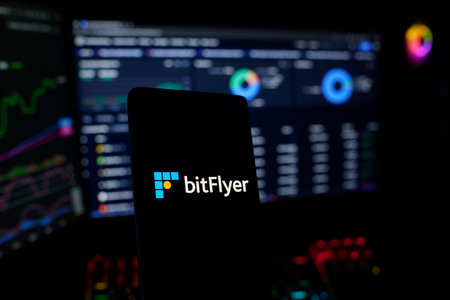 Close up of mobile phone screen showing logo of Bitflyer on display. Bitflyer is a cryptocurrency...