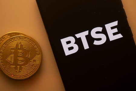 Dhaka, Bangladesh 22 September 2025:A Bitcoin coin paired with a smartphone displaying the BTSE logo...