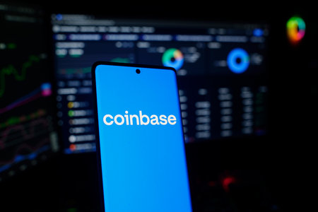 Dhaka, Bangladesh 26 September 2025:Coinbase logo on a smartphone in front of a trading screen setupのeditorial素材