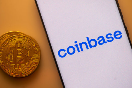 Dhaka, Bangladesh 22 September 2025:Coinbase app displayed on a smartphone beside a Bitcoin coin imageのeditorial素材