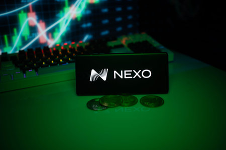 Dhaka, Bangladesh 18 September 2025:NEXO on a smartphone with currency tokens and fluctuating charts behindのeditorial素材