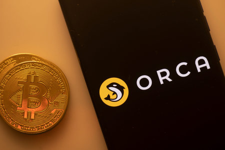 Dhaka, Bangladesh 22 September 2025:A Bitcoin and Orca logo on a black screen with a yellow circle