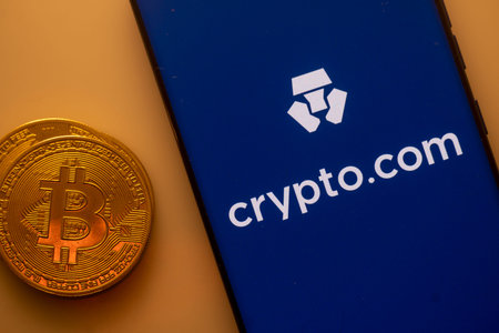 Dhaka, Bangladesh 22 September 2025:A Bitcoin and Crypto.com logo on a blue screen representing...