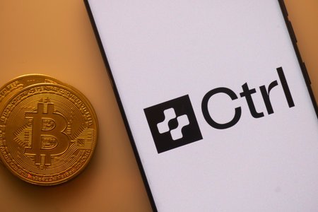 Dhaka, Bangladesh 22 September 2025:Bitcoin and Ctrl logo displayed on a smartphone with orange ambient lightingのeditorial素材