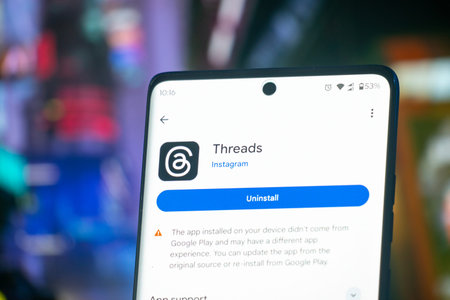 Dhaka, Bangladesh 07 Dec 2025:Threads app logo seen on screen. The new application by Meta Platforms is Twitter competitor.のeditorial素材