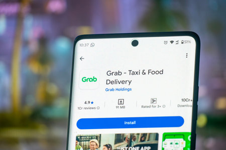 Dhaka, Bangladesh 26 Dec 2025:The Grab app appears on the smartphone screen. Grab Taxi is a technology company based in Singaporeのeditorial素材