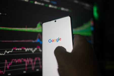 Dhaka, Bangladesh 20 Feb 2026:A smartphone displaying the Google logo in front of stock charts on a...