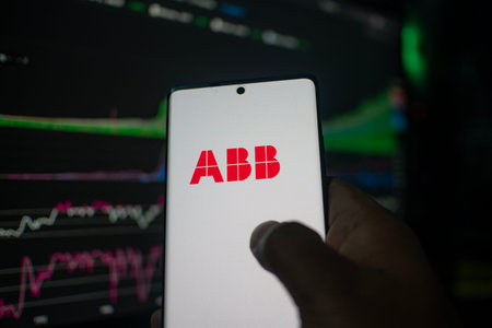 Dhaka, Bangladesh 20 Feb 2026:Smartphone showing ABB logo against a financial chart backdrop
