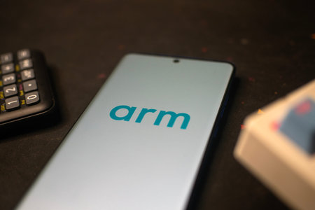 Dhaka, Bangladesh 20 Feb 2026:Arm logo on a smartphone surrounded by various office itemsのeditorial素材