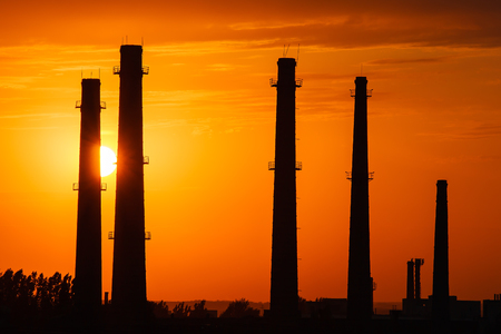 Silhouette of industrial factory at gold sunsetの写真素材