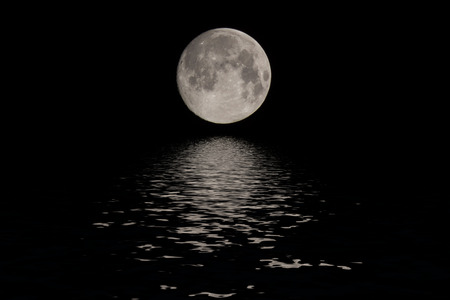 Full moon reflected water over dark black sky at nightの写真素材