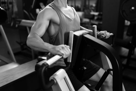 Man working on fitness machine at gym