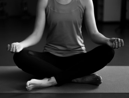 One woman practicing yoga on a matの写真素材