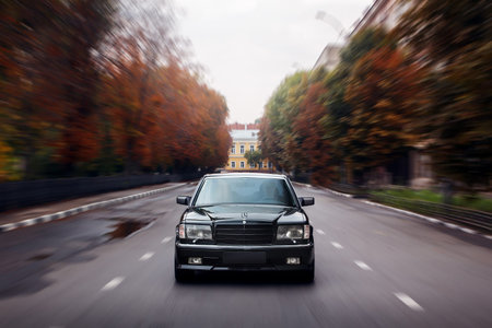 Saratov, Russia - September 28, 2014: Black car Mercedes-Benz speed drive on asphalt road in city at...