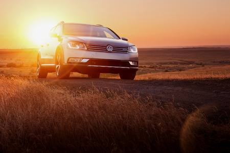 Saratov, Russia - June 02, 2014: Grey car Volkswagen Passat stay on dirt road at sunsetのeditorial素材