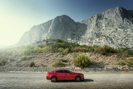 Crimea, Russia - September 20, 2015: Red car Mazda standing on the road near mountains at daytimeのeditorial素材