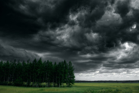 Dramatic thunder storm clouds at dark sky. Nature landscapeの写真素材