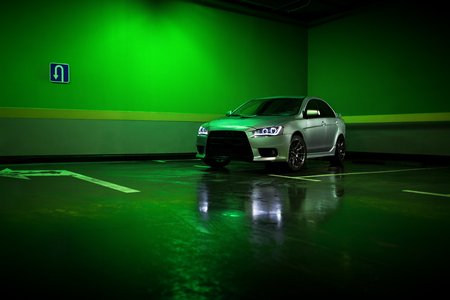 Moscow, Russia - June 18, 2016: Gray car Mitsubishi Lancer stay at underground parking lot and reflect in wet asphaltのeditorial素材
