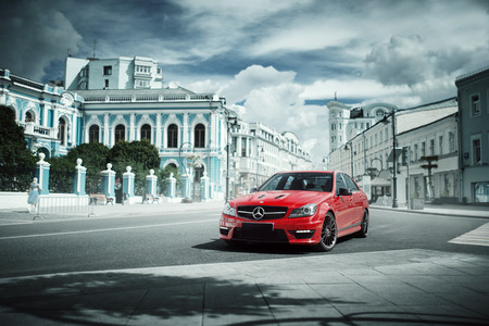 Moscow, Russia - July 10, 2016: Red car Mercedes-Benz C63 AMG stay on asphalt road in the city Moscow at daytimeのeditorial素材