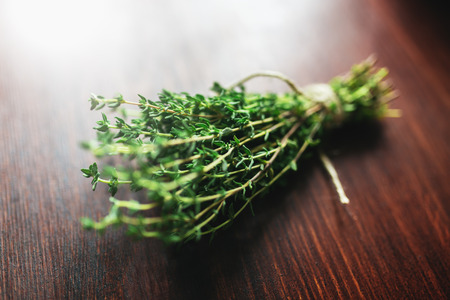 Fresh green bunch of thyme on wooden backgroundの写真素材