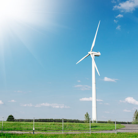 Energy windmill produce energy on blue sky at daytime