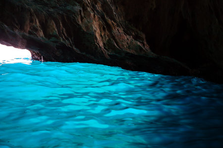 Sea cave with blue water at daytime