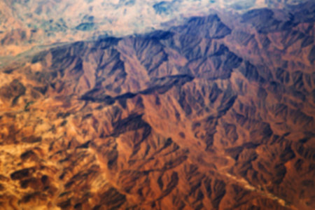 Aerial view from air plane of desert mountains, blur background