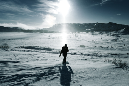 Man traveler with backpack at winter mountainの写真素材