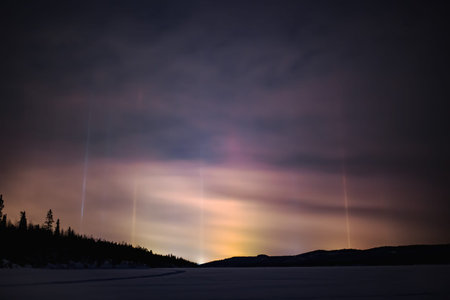 Light pillar hallo effect in atmosphere at nightの写真素材