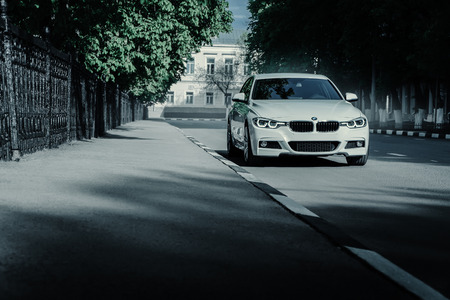 Saratov, Russia - May 07, 2017: White BMW 3 Series F30 car standing on empty asphalt road at summer daytimeのeditorial素材