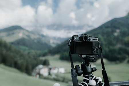 Digital camera on flexible portable tripod taking a landscape pictureの写真素材