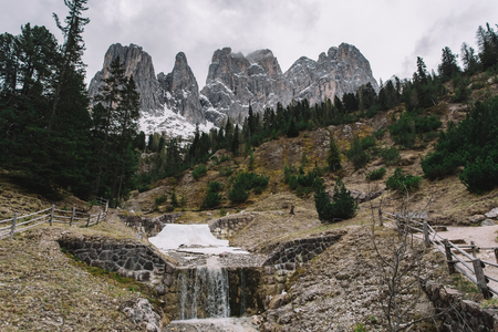 Green forest and snowy mountains. Dolomites Alpsの写真素材