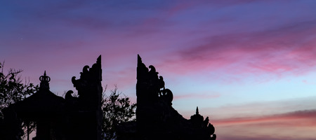 Enjung Galuh Temple Silhouette at dusk. Pink sunset in Bali, Indonesiaの写真素材