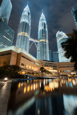 Petronas Twin Towers reflected in water. Kuala Lumpur City Centre Park at night