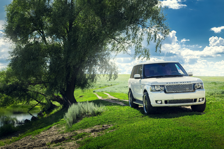 Saratov, Russia - July 12, 2017: Car Land Rover Range Rover is standing near lake and forest at summer dayのeditorial素材