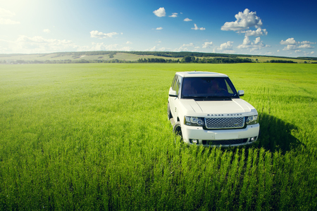 Saratov, Russia - July 12, 2017: Car Land Rover Range Rover is standing at green grass meadow at summer dayのeditorial素材