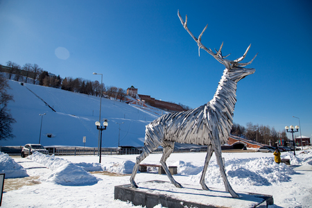 Nizhny Novgorod, Russia - March 09, 2018: Deer monument and Kremlin Wall. Deer is symbol of Nizhny Novgorod city. Russia at winterのeditorial素材