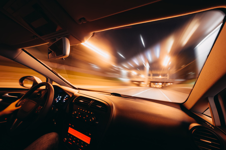 Car speed drive on the road in night cityの写真素材