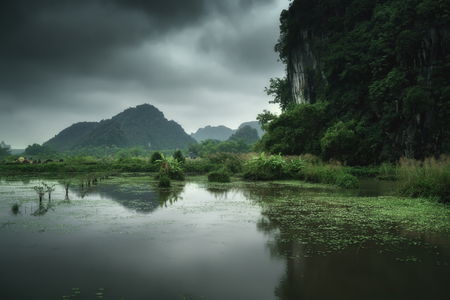 Vietnam nature landscape green mountains reflected in the waterの写真素材