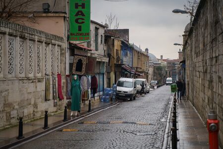 Istanbul, Turkey - December 17, 2018: Local people are waking at narrow streets of old town district in Istanbul, Turkey at rainy dayのeditorial素材