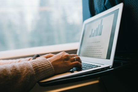 Typing using laptop computer in the train. Business work travelの写真素材