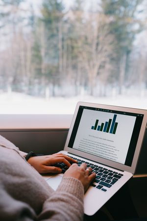 Typing using laptop computer in the train. Business work travelの写真素材