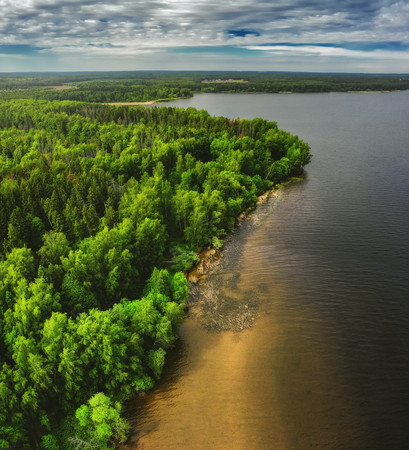 Nature landscape, drone aerial top view to green forest and lakeの写真素材