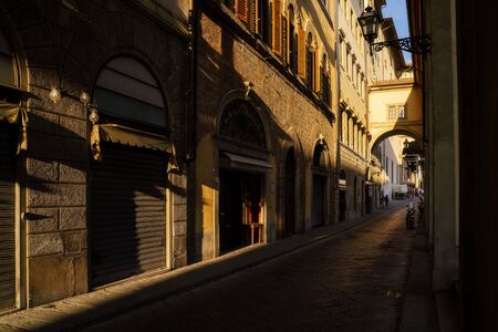 Narrow street in Florence city, Italy in the sunsetの写真素材