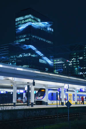 Amsterdam, Netherlands - March 7, 2020: Train is parked at the platform in railway station at night in Amsterdam city downtown at nightのeditorial素材
